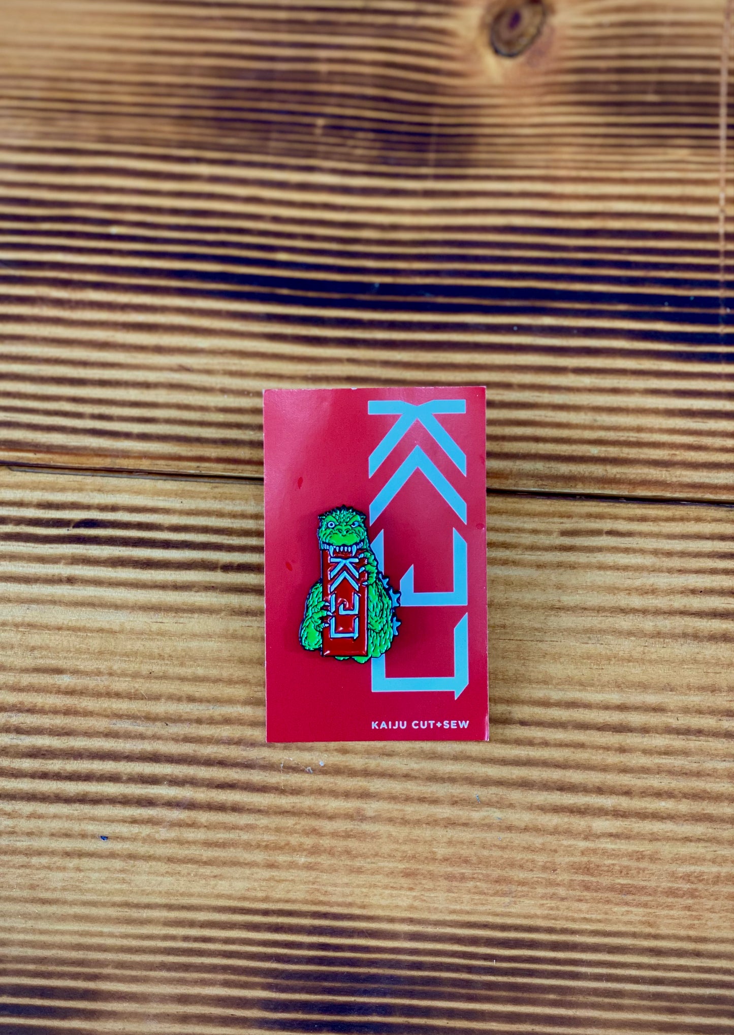 Kaiju Cut and Sew + Godzilla Biting Logo Enamel Pin